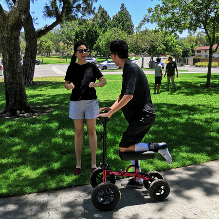 Tuffcare All-Terrain steerable knee walker being used in the park. 